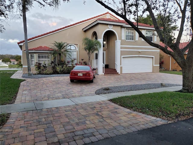 mediterranean / spanish-style home featuring a garage