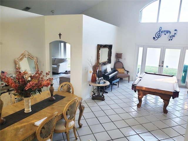 rec room featuring french doors, a high ceiling, and light tile patterned flooring