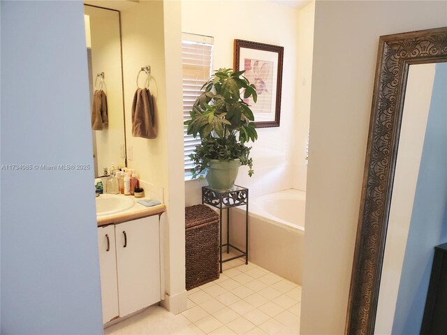 bathroom featuring tile patterned flooring, a bathing tub, and vanity