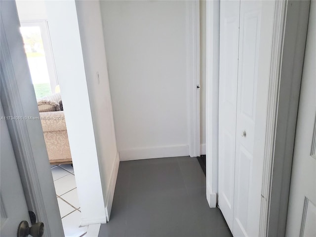 hallway with dark tile patterned flooring