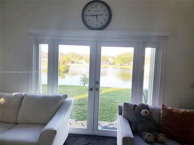 entryway with a wealth of natural light, french doors, and a water view