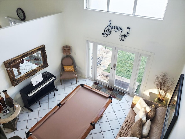 recreation room with light tile patterned floors, billiards, french doors, and a high ceiling