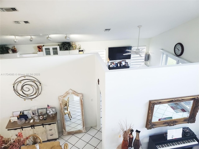 room details featuring ceiling fan and track lighting