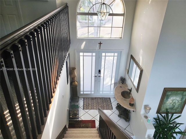 entrance foyer featuring tile patterned flooring and a towering ceiling