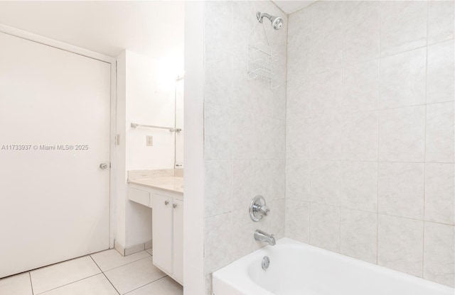 bathroom with vanity, tiled shower / bath combo, and tile patterned flooring