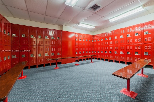 miscellaneous room with carpet flooring and a drop ceiling