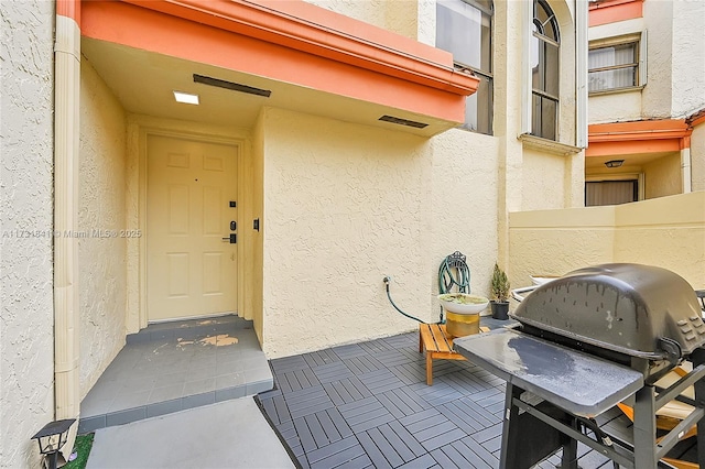 doorway to property with stucco siding