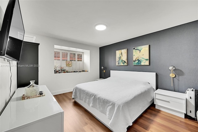 bedroom featuring wood-type flooring