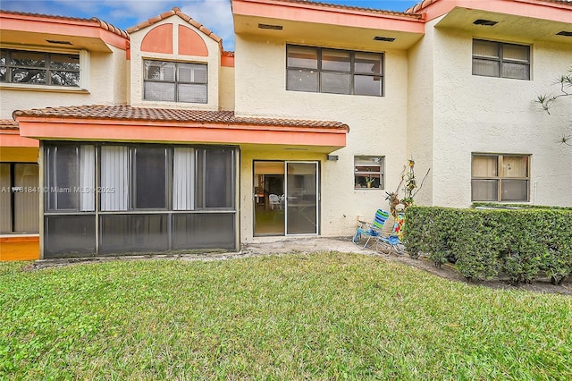 rear view of house with a yard