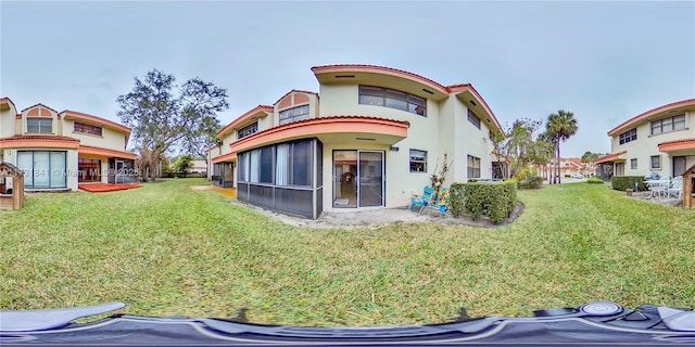 rear view of property featuring a yard