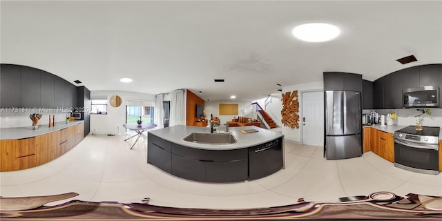 kitchen featuring stainless steel appliances, sink, and light tile patterned floors