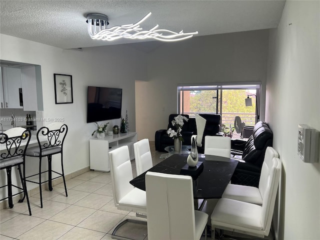 tiled dining space with a textured ceiling