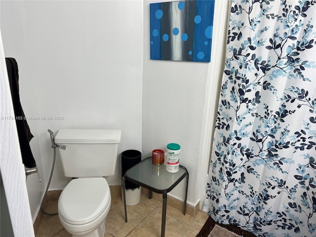 bathroom featuring tile patterned flooring and toilet