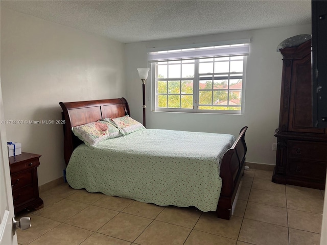 tiled bedroom with a textured ceiling