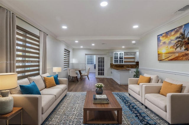 living room with ornamental molding and dark hardwood / wood-style flooring