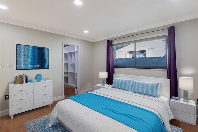 bedroom with crown molding and dark hardwood / wood-style floors