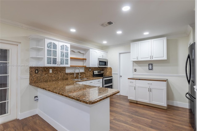 kitchen featuring appliances with stainless steel finishes, white cabinets, and kitchen peninsula