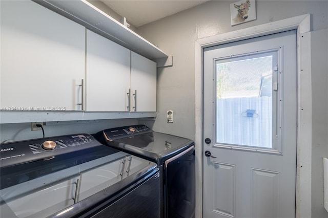 washroom with cabinets and washer and clothes dryer