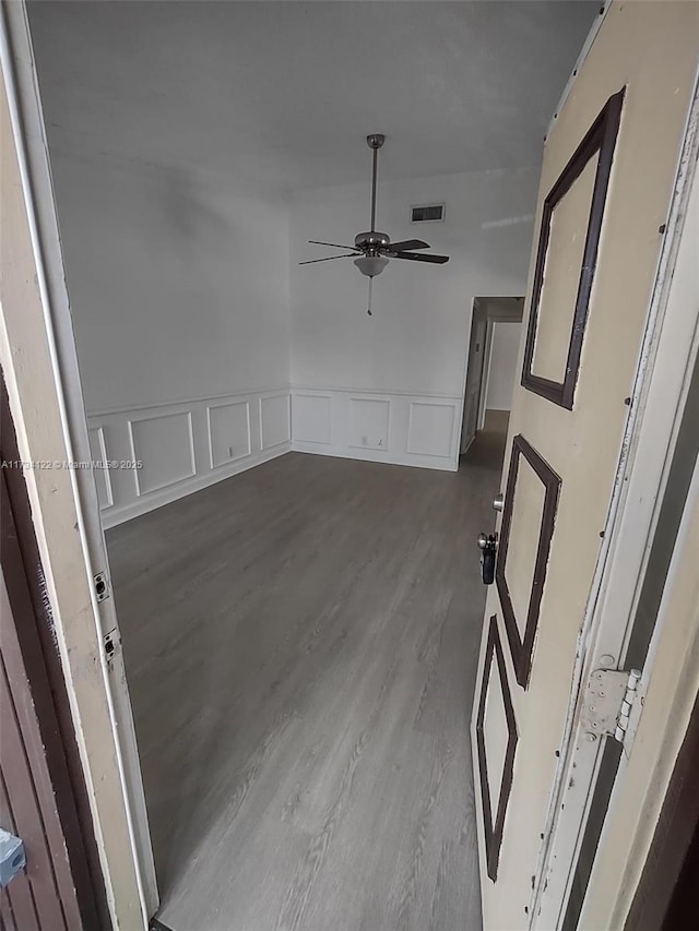 empty room featuring ceiling fan and wood-type flooring