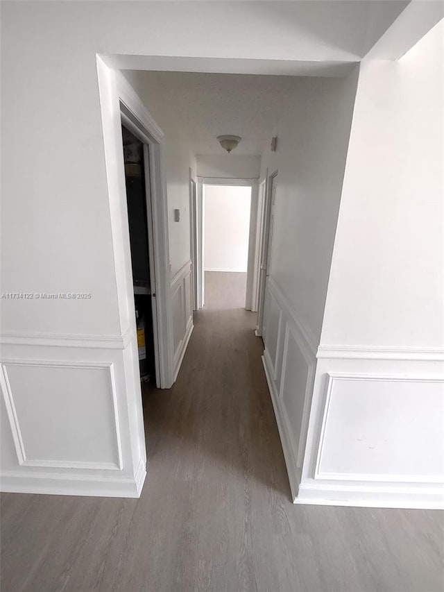 corridor with wood-type flooring