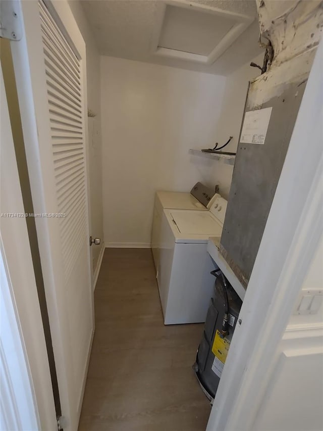 laundry room with light hardwood / wood-style flooring and washing machine and dryer