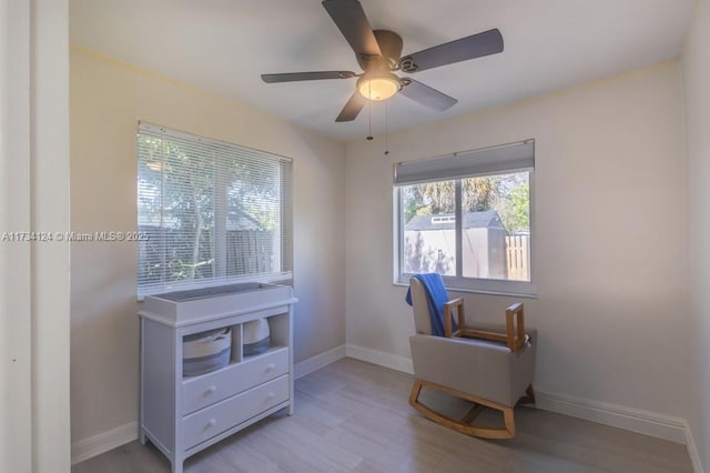 living area featuring ceiling fan