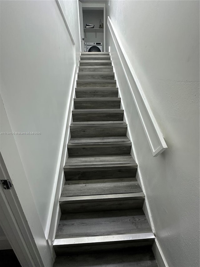 staircase featuring washer / clothes dryer