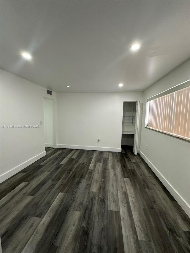 spare room with dark hardwood / wood-style flooring