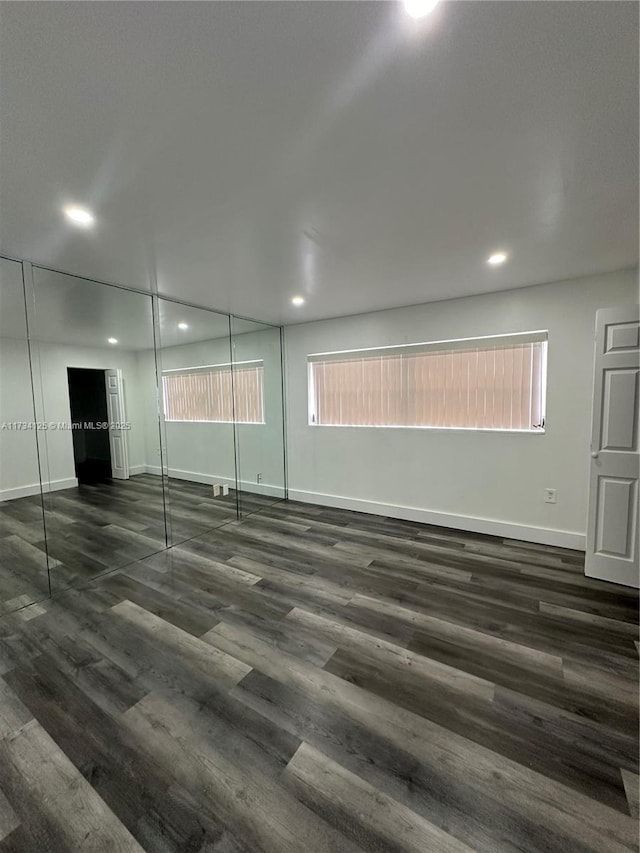 spare room featuring dark wood-type flooring