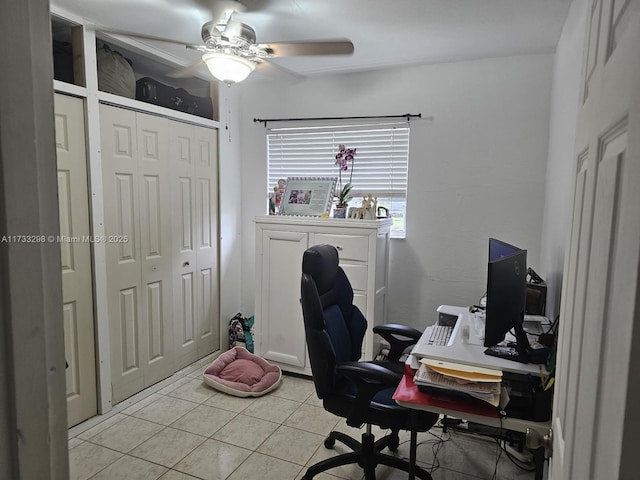 office area with light tile patterned floors and ceiling fan