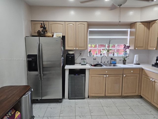 kitchen featuring sink, light brown cabinets, stainless steel fridge, ceiling fan, and beverage cooler