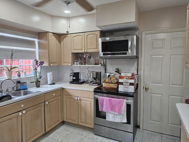 kitchen with ceiling fan, stainless steel appliances, and sink