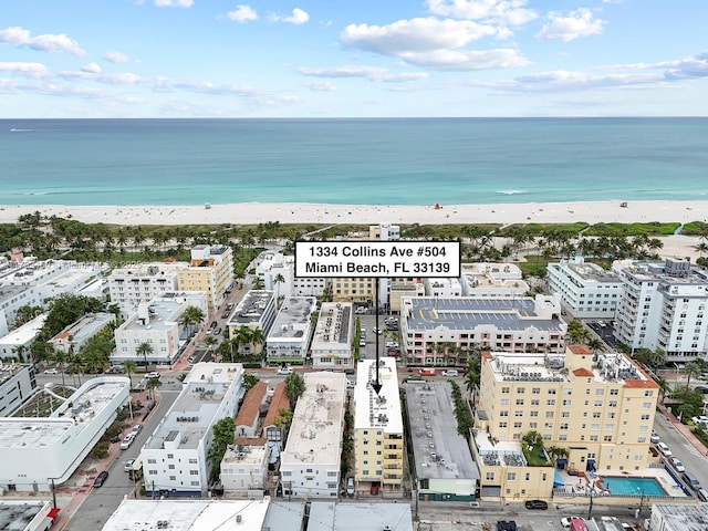 birds eye view of property with a view of the beach and a water view