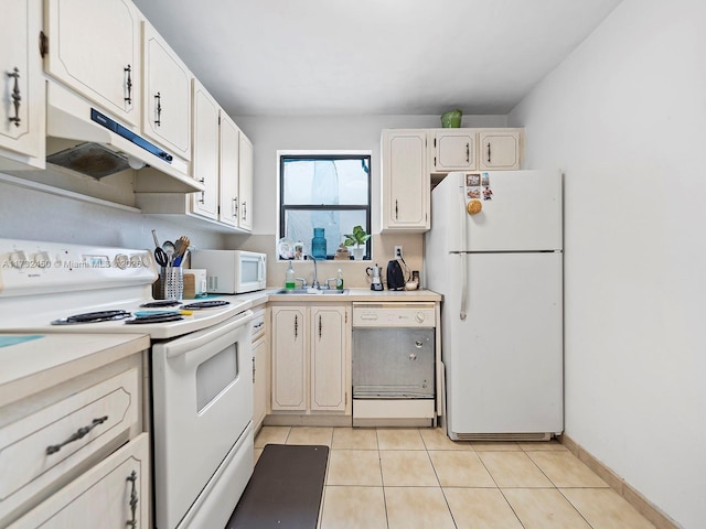 kitchen featuring white cabinetry, sink, light tile patterned flooring, and white appliances