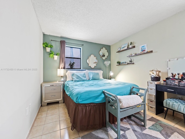 bedroom with light tile patterned floors and a textured ceiling