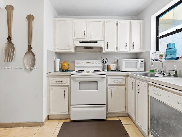 kitchen with sink, white cabinetry, light tile patterned floors, pendant lighting, and white appliances