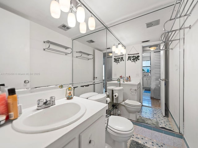 bathroom with vanity, tile patterned floors, and toilet