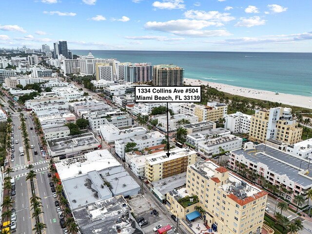 aerial view with a water view and a view of the beach