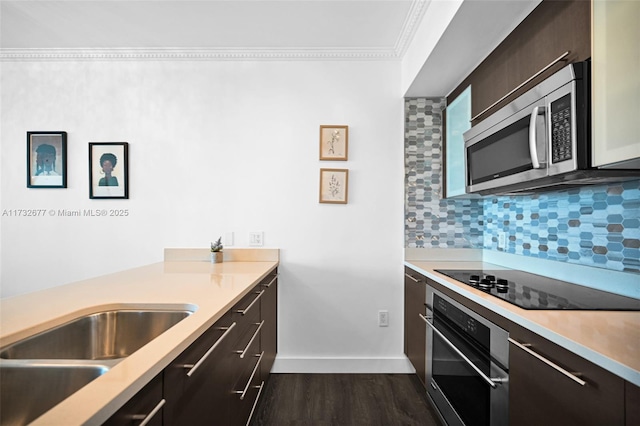 kitchen with dark hardwood / wood-style flooring, decorative backsplash, ornamental molding, dark brown cabinetry, and stainless steel appliances