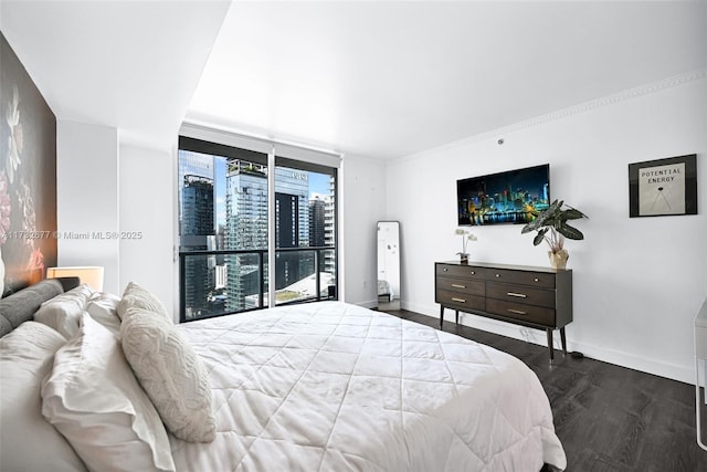 bedroom featuring a wall of windows and dark hardwood / wood-style floors