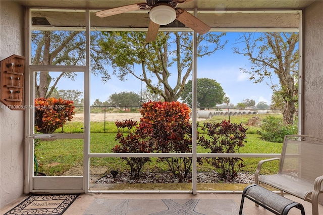 sunroom featuring a healthy amount of sunlight and ceiling fan