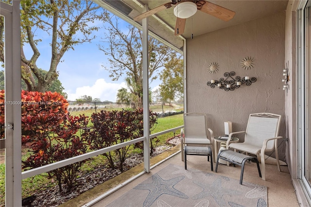 sunroom / solarium featuring ceiling fan