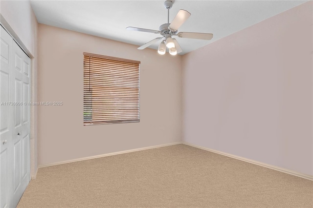 interior space with light carpet, a closet, and ceiling fan