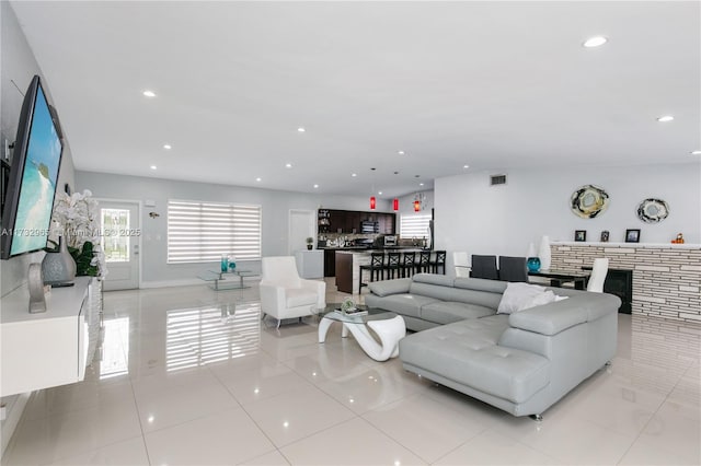 tiled living room featuring a fireplace