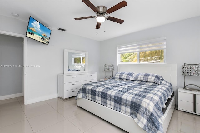 bedroom with ceiling fan and light tile patterned floors