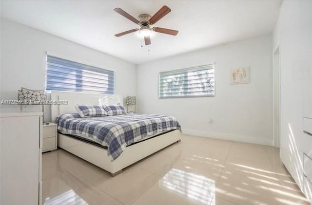 bedroom featuring ceiling fan and tile patterned floors
