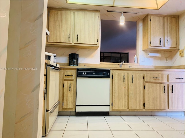 kitchen with pendant lighting, light tile patterned floors, dishwasher, track lighting, and light brown cabinets