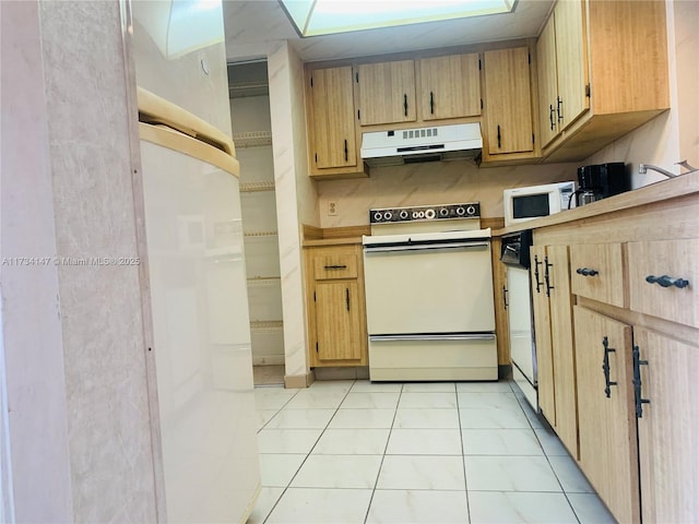 kitchen featuring white appliances and light tile patterned floors