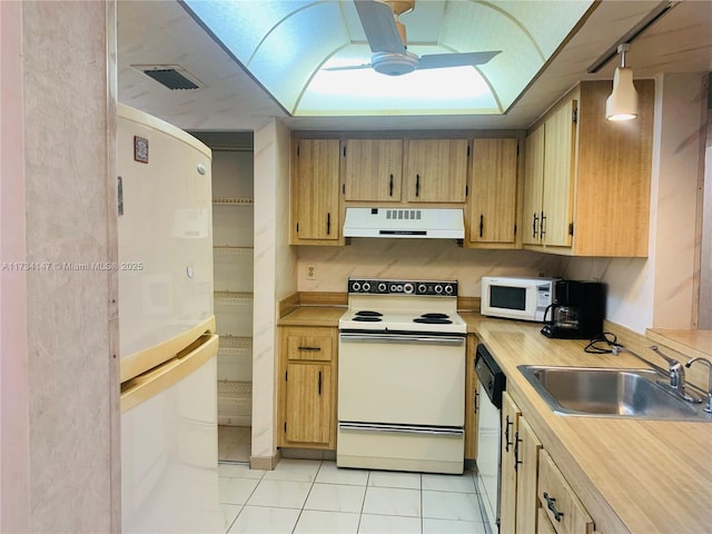 kitchen with light tile patterned flooring, sink, ceiling fan, pendant lighting, and white appliances