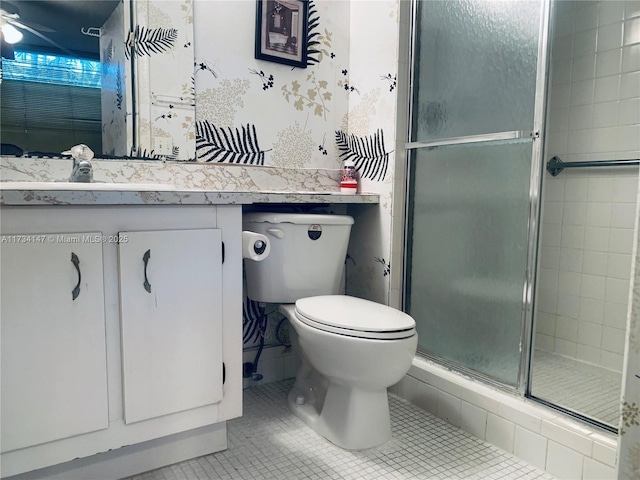 bathroom with tile patterned floors, toilet, an enclosed shower, and vanity